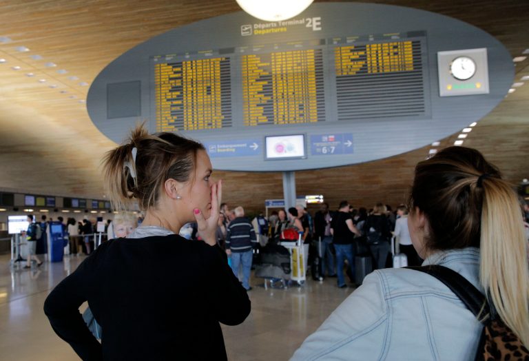 Margaux Hengel, right, and Stephanie Leon of France react after their flight is canceled at Paris Charles de Gaulle airport, in Roissy, near Paris, Wednesday, Sept. 17, 2014. Air France canceled at least half its flights around the world on Monday as pilots began a weeklong strike, highlighting the trouble Europe's flagship airlines face in keeping up with low-cost competitors. Both 24-year-old medical workers, already made a sacrifice before dawn on Wednesday. They hurriedly bought tickets on a 4-hour train to catch their flight to the Caribbean after their first-leg flight from Brest, in western France, to Paris was canceled. (AP Photo/Christophe Ena)