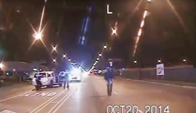 FILE - In this Oct. 20, 2014 file image taken from dash-cam video provided by the Chicago Police Department, Laquan McDonald, right, walks down the street moments before being fatally shot by Chicago Police officer Jason Van Dyke in Chicago. Three Chicago police officers have been indicted on felony charges alleging they conspired to cover up the fatal shooting of black teen Laquan McDonald by a white officer. The three officers, Thomas Gaffney, David March and Joseph Walsh, were each charged Tuesday, June 27, 2017, with conspiracy, official misconduct and obstruction of justice. (Chicago Police Department via AP, File)