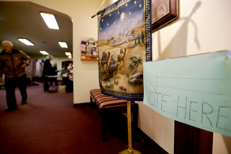 Rudy Humlicek, left, leaves a polling station in Fremont, Neb., after casting his ballot, Tuesday, Feb. 11, 2014. Fremont voters are voting on whether to scrap the city's housing restrictions that were supposed to make it hard for people living in the country illegally to live there. This new vote on the ordinance voters approved in 2010 was scheduled because city leaders are worried about possibly losing federal grants and racking up big legal bills defending the law. (AP Photo/Nati Harnik)