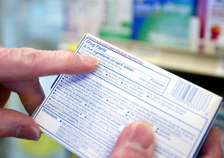 Pharmacist Ed Cole points out the active ingredient of over-the-counter cold medicine at Hi-School Pharmacy store on July 20, 2005 in Milwaukie, Oregon. (Photo by Craig Mitchelldyer/Getty Images)