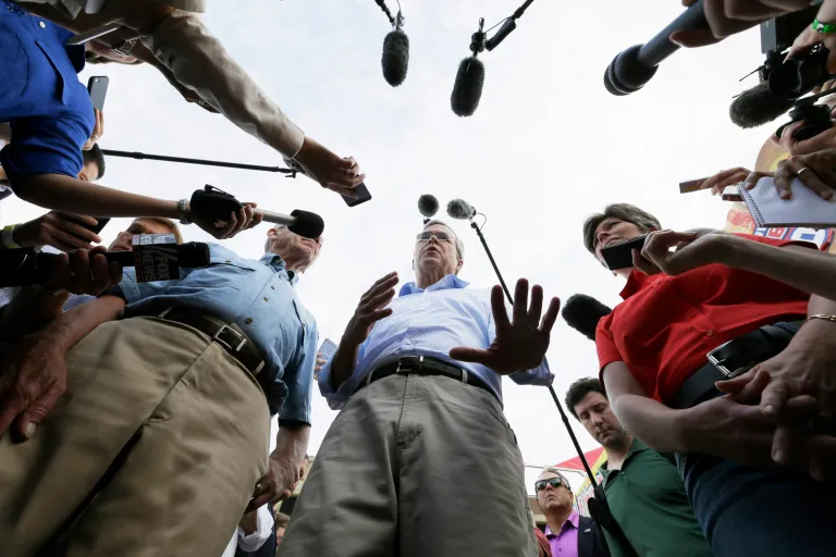 Republican presidential candidate, former Florida Gov. Jeb Bush, center, accompanied by Sen. Charles Grassley, R-Iowa, left, and Sen. Joni Ernst, R-Iowa, speaks to reporters during a visit to the Iowa State Fair, Friday, Aug. 14, 2015, in Des Moines, Iowa. (AP Photo/Charlie Neibergall))
