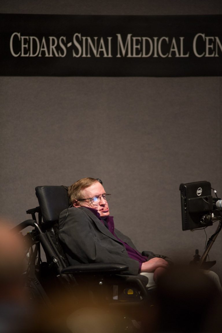 In this photo provided by Cedars-Sinai, British cosmologist Stephen Hawking, who has motor neuron disease, gives a talk titled 