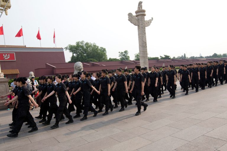 Female and male security guards march in front of Tiananmen Gate in Beijing, China, Saturday, May 31, 2014. A quarter century after the TiananmenSquare pro-democracy movementâs suppression, Chinaâs communist authorities oversee a raft of measures for muzzling dissent and preventing protests. They range from the sophisticated extensive monitoring of online debate and control over media to the relatively simple routine harassment of government critics and maintenance of a massive domestic security force. (AP Photo/Alexander F. Yuan)