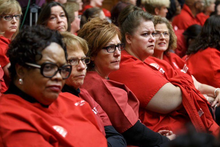 Members of National Nurses United, the largest union and professional association of registered nurses in the U.S., listen from the audience on Capitol Hill in Washington, Friday, Oct. 24, 2014, as the House Oversight Committee examines the government's response to the Ebola outbreak. On Thursday, a fourth Ebola case was diagnosed in the U.S. -- a doctor in New York City who had treated patients in Guinea. (AP Photo/J. Scott Applewhite)