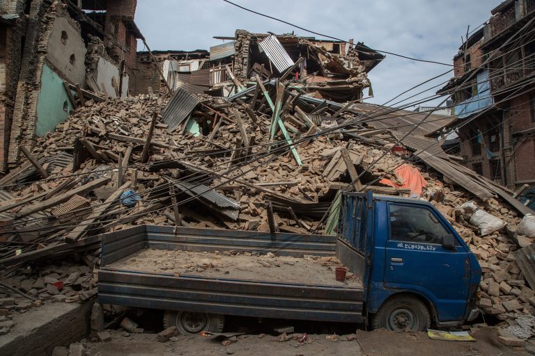 A truck is covered in debris from a collapsed building on April 26, 2015 in Bhaktapur, Nepal. (Photo by Omar Havana/Getty Images)