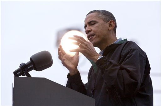 A light shines behind President Barack Obama as he speaks during a campaign event at Bayliss Park, Monday, Aug. 13, 2012, in Council Bluffs, Iowa, during a three day campaign bus tour through Iowa. (AP Photo/Carolyn Kaster)