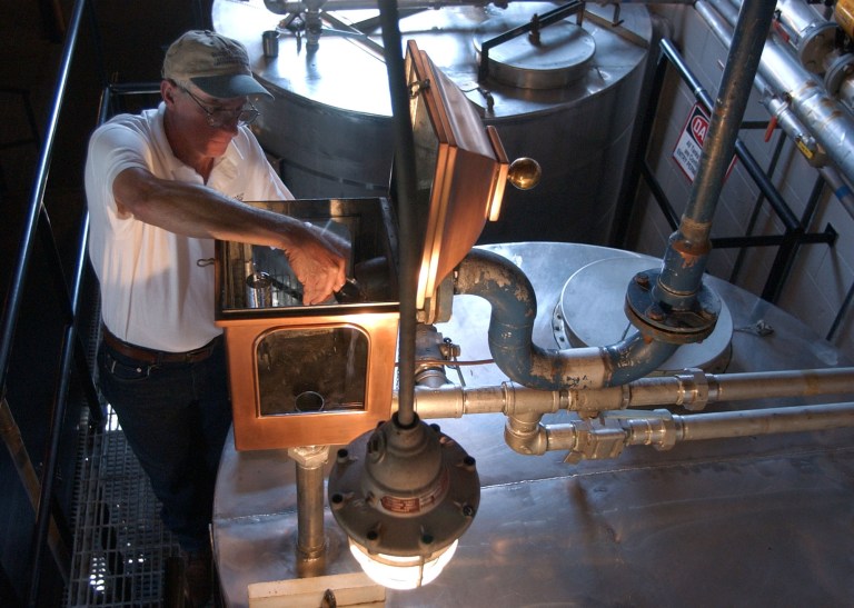 FILE -- In this Sept. 2003 file photo, Gary Hinshaw tests the proof of the whiskey at the George Dickel Distillery near Tullahoma, Tenn. Alcohol regulators ended their investigation Tuesday, June 10, 2014, into whether George Dickel, a subsidiary of liquor giant Diageo, violated state laws by storing whiskey in neighboring Kentucky. (AP Photo/Mark Humphrey, File)