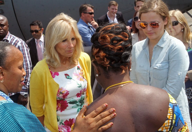 Jill Biden, second left, the wife of American Vice-President Joe Biden, speaks with people at a school project that benefits from American Aid money in Bukavu, Democratic Republic of Congo, Saturday, July 5, 2014.  Jill Biden, the wife of Vice President Joe Biden, is highlighting female empowerment, education and leadership on a tour of three African countries this week, including the DRC. (AP Photo/John Bompengo)