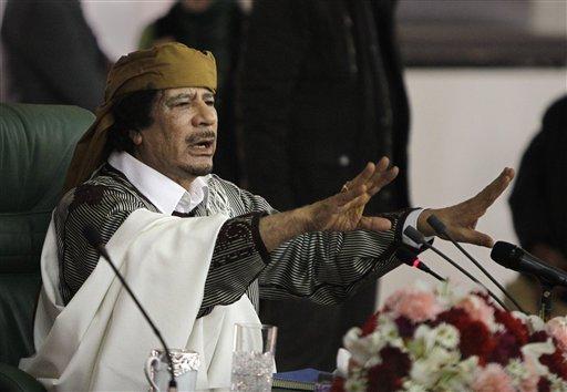 In this March 2, 2011 file photo, Libyan Leader Moammar Gadhafi gestures to supporters as he speaks in Tripoli, Libya. The deposed dictator is on the run and has few options to turn to after rebel forces captured Tripoli last week.