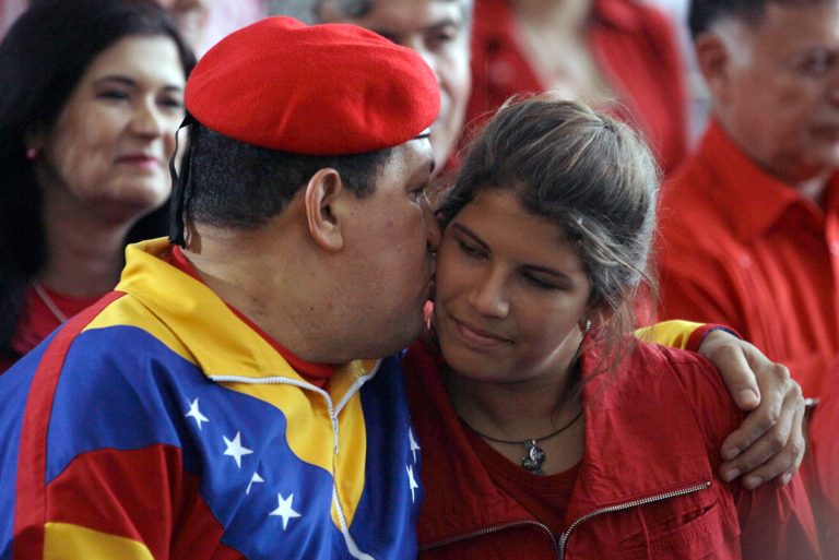   Venezuela's President Hugo Chavez, left, kisses his daughter Rosines during a ceremony to register his candidacy for the presidency at the National Elections Council, CNE, in Caracas, Venezuela, Monday, June 11, 2012. Chavez rallied thousands of his supporters Monday, wearing his signature red beret and singing a folk song as he formalized his presidential candidacy and launched his re-election bid. (AP Photo/Fernando Llano)  