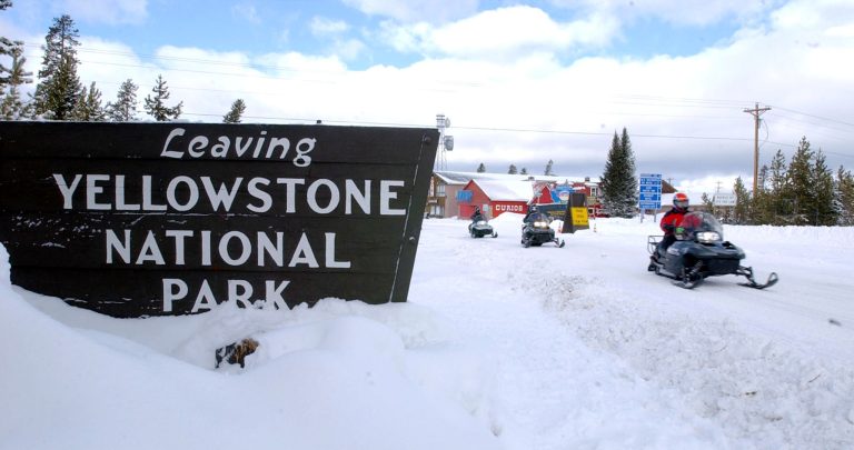 A trio of snowmobilers enter Yellowstone National Park in west Yellowstone, Montana. (Bill Schaefer/Getty Images)