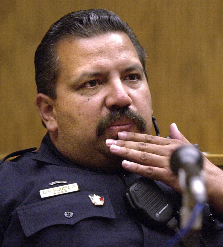   FILE - In this May 10, 2001, file photo, El Cajon, Calif., Police department school resource officer Rich Agundez Jr., who confronted and wounded a student who attacked Granite Hills High School with a shotgun in 2001, testifies in El Cajon. The National Rifle Associationâs response to a Connecticut school massacre envisions, in part, having trained, armed volunteers in every school in America. But Agundez, school safety experts and school board members say thereâs a huge difference between a trained law enforcement officer who becomes part of the school family _ and a guard with a gun. (AP Photo/U-T San Diego, John Gastaldo) SAN DIEGO COUNTY OUT; NO SALES; COMMERCIAL INTERNET OUT; FOREIGN OUT  