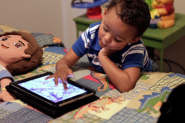   FILE - In this Friday, Oct. 21, 2011 file photo, Frankie Thevenot, 3, plays with an iPad in his bedroom at his home in Metairie, La. As of Wednesday, Aug. 7, 2013, the Campaign for a Commercial-Free Childhood, a Boston-based group, is urging federal investigators to examine the marketing practices of Fisher-Price's and Open Solution's mobile apps. It's the campaign's first complaint against the mobile app industry as part of its broader push to hold accountable businesses that market technology to very young children and their parents. (AP Photo/Gerald Herbert, File)  
