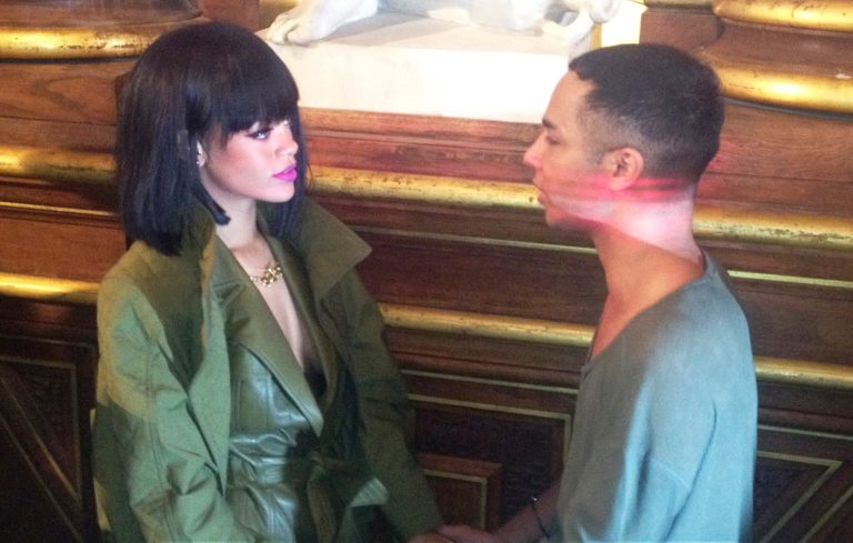Singer Rihanna holds hands with Balmain fashion designer Olivier Rousteing after Balmain's ready-to-wear fall/winter 2014-2015 fashion collection presented in Paris, Thursday, Feb. 27, 2014. (AP Photo/Thomas Adamson)