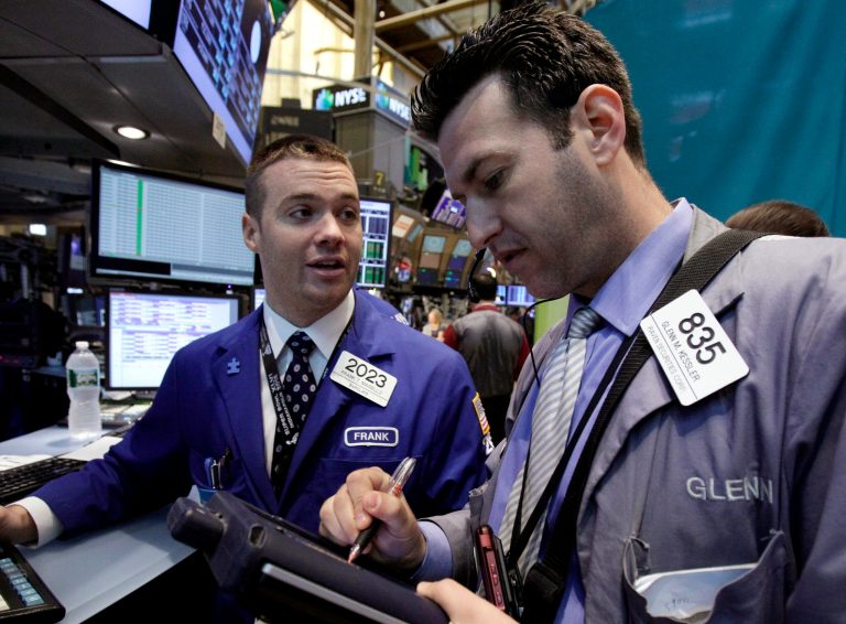   FILE- In this Monday, June 11, 2012, file photo, Specialist Frank Masiello, left, and trader Glenn Kessler work on the floor of the New York Stock Exchange. Wall Street was on course to open higher Friday June 15, 2012, with Dow Jones industrial futures rising 0.4 percent to 12,650. S&P 500 futures gained 0.4 percent to 1,331.30. (AP Photo/Richard Drew, File)  