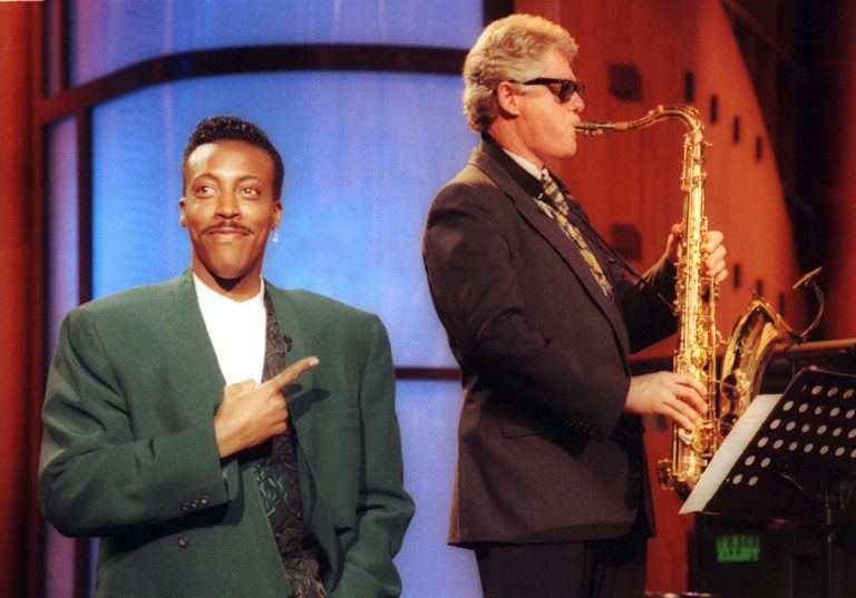 FILE - This June 3, 1992 file photo shows Arkansas Gov. Bill Clinton, right, playing the saxaphone with the band during the musical opening of 