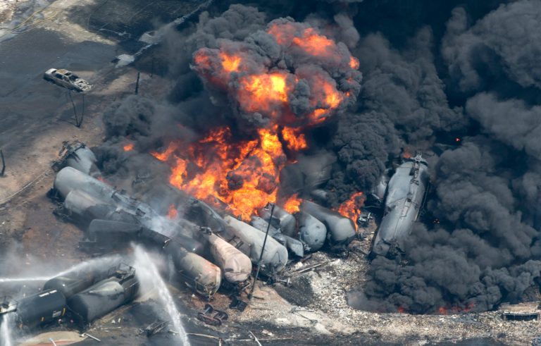 Smoke rises from derailed train cars that were carrying crude oil in downtown Lac-MÃ©gantic, Quebec, Saturday, July 6, 2013. (AP Photo/The Canadian Press, Paul Chiasson)
