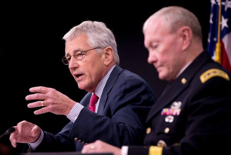 Defense Secretary Chuck Hagel, left, accompanied by Joint Chiefs Chairman Gen. Martin Dempsey, briefs reporters at the Pentagon, Thursday, July 3, 2014. (AP Photo/Pablo Martinez Monsivais)