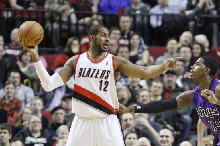   Portland Trail Blazers forward LaMarcus Aldridge, left, points to other players as Sacramento Kings forward Jason Thompson defends during the first quarter of their NBA basketball game in Portland, Ore., Saturday, Dec. 8, 2012.(AP Photo/Don Ryan)  