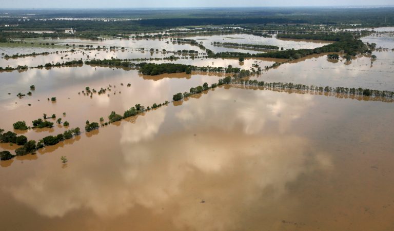 In the wake of deadly tragedies, wait until after all of the corpses have been collected before taking political cheap shots. Fields are submerged by water from the flooded Brazos River in the aftermath of Hurricane Harvey on Friday. (AP Photo/Charlie Riedel)