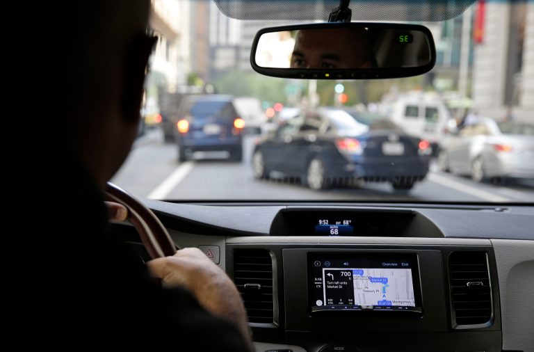 In this photo taken Wednesday, May 14, 2014, Ted Cardenas, a marketing vice president with Pioneer Electronics, demonstrates the new Apple CarPlay powered by Pioneer, while navigating through the Financial District in San Francisco. Utilizing large, in-dash Pioneer LCD displays, CarPlay, featuring Siri voice control, gives iPhone users the features while allowing them to stay focused on the road. (AP Photo/Eric Risberg)