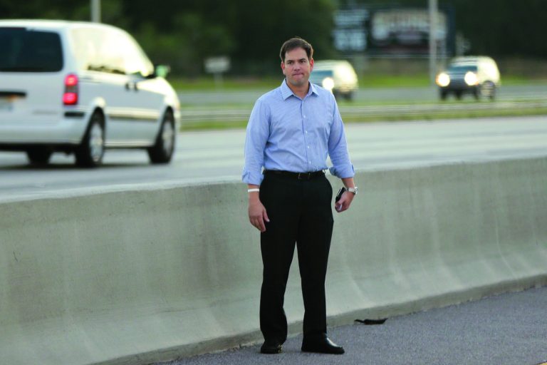 Sen. Marco Rubio, R-Fla., who is traveling with Republican presidential candidate and former Massachusetts Gov. Mitt Romney, stands alongside Interstate 4 in Lakewood Crest, Fla., Saturday, Oct. 27, 2012 after the motorcade was stopped. The 12-year-old daughter of Sen. Rubio had been airlifted to a hospital after a Saturday motor vehicle accident. A Rubio spokesman reports that the girl is in stable condition. (AP Photo/Charles Dharapak)