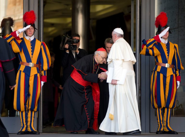 General Secretary of the Synod Cardinal Lorenzo Baldisseri bows as he welcomes Pope Francis for the morning session of a two-week synod on family issues including contraception, pre-marital sex and divorce, at the Vatican, Monday, Oct. 6, 2014. 200 cardinals and bishops from around the world have arrived in Rome for the meeting. (AP Photo/Alessandra Tarantino)