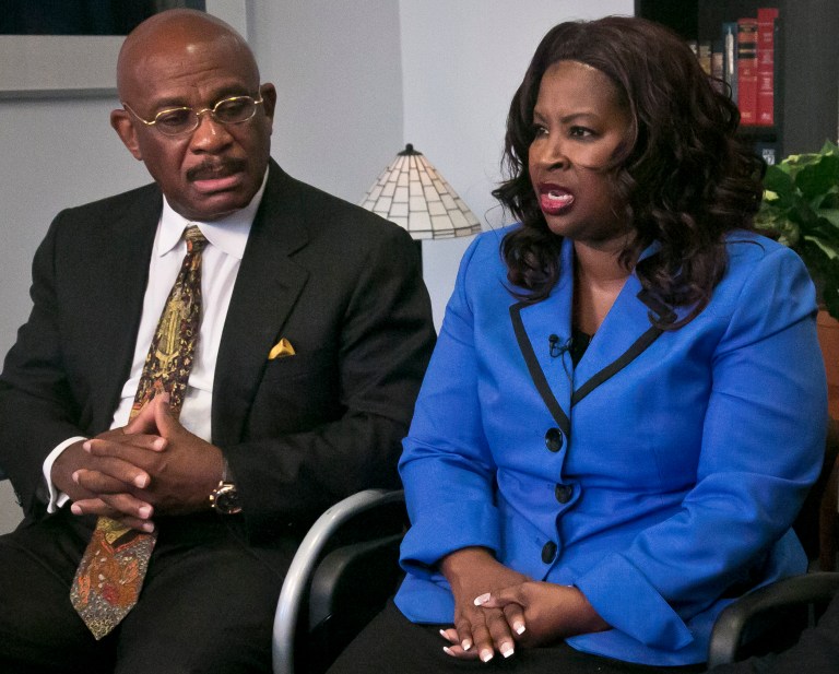 Attorney Willie Gary, left, listens as Cynthia Robinson speaks during an interview, Monday, July 21, 2014 in New York.  Gary represented Robinson in a lawsuit against R.J. Reynolds Tobacco Co.  The No. 2 U.S. cigarette maker is vowing to fight a jury verdict of $23.6 billion in punitive damages Gary won for Robinson on behalf of her late husband, Michael Johnson Sr., who died of lung cancer. (AP Photo/Bebeto Matthews)