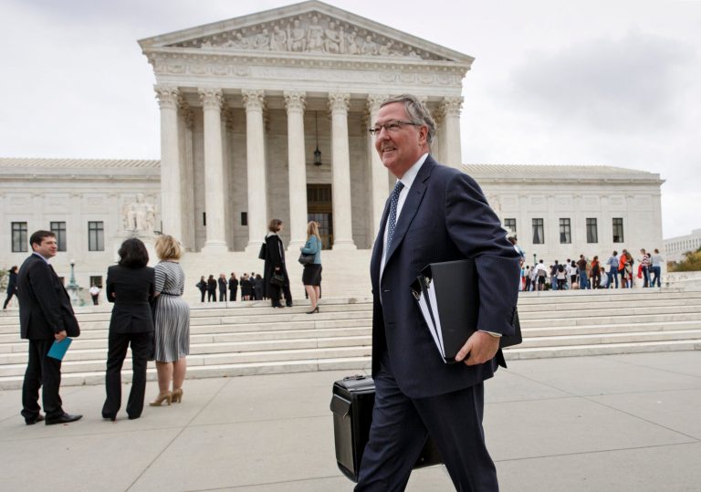 Attorney Carter G. Phillips, representing generic drug maker Mylan Pharmaceuticals, departs the Supreme Court in Washington, Wednesday, Oct. 15, 2014, after arguments in Teva Pharmaceuticals U.S.A., Inc. v. Sandoz, Inc. Justices seem divided as it considers a high stakes patent dispute between rival pharmaceutical companies over the world's best-selling multiple sclerosis treatment, a case that threatens to cut into the $4 billion-a-year profits that Israel-based Teva Pharmaceutical Industries Ltd. earns selling the drug Copaxone. Teva claims the U.S. Court of Appeals for the Federal Circuit wrongly overturned five of its patents for the drug.   (AP Photo/J. Scott Applewhite)