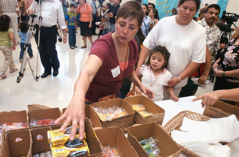 Paraeducator Rita Felices hands out ice cream at an open house held at Highland Elementary School in Silver Spring on Friday, August 25, 2006.  (Jeff Mankie/Examiner)