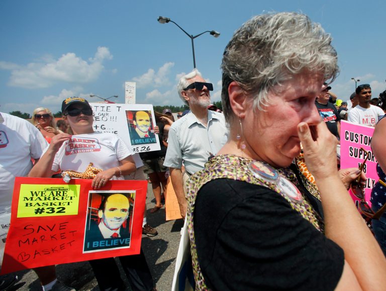 Longtime customer Nancy Kindler of Epping, N.H. becomes emotional during a rally in front of Market Basket in Tewksbury, Mass., Tuesday, Aug. 5, 2014. Thousands of Market Basket supermarket employees and their supporters are calingl for the reinstatement of their fired CEO, even as the company began a three-day job fair to replace employees who have refused to work during a revolt that is costing the supermarket chain millions. (AP Photo/Elise Amendola)