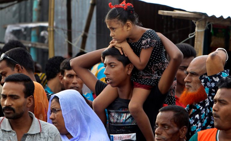 Bangladeshi people gather on the banks of the River Padma where a passenger ferry capsized Monday in Munshiganj district, Bangladesh, Tuesday, Aug. 5, 2014. More than 200 people were believed to be on board the M.V. Pinak when it capsized Monday. Families of scores of people presumed dead accused authorities on Tuesday of launching a feeble rescue effort and leaving their loved ones trapped inside the vessel for more than 24 hours. (AP Photo/ A.M. Ahad)