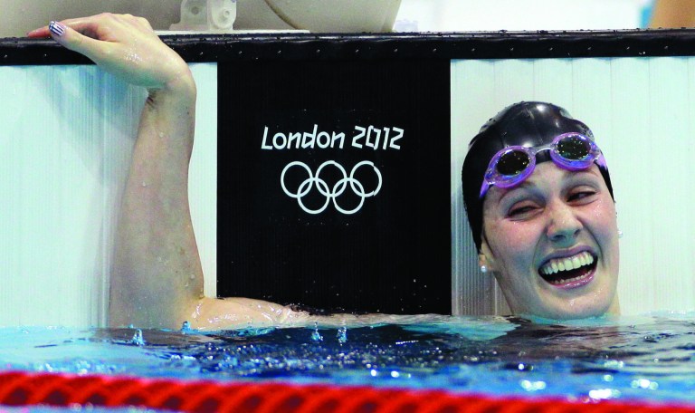 Phelps goes out in style, rallying in 100 fly