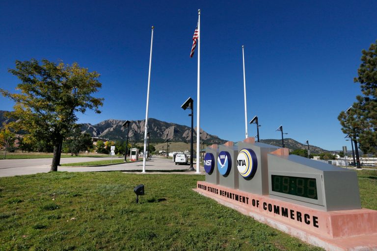 An American flag flies in front of a U.S. Dept. of Commerce facility, which houses the National Institute of Standards and Technology and other Federal Government operations, in Boulder, Colo.,Tuesday Oct. 1, 2013. (AP Photo/Brennan Linsley)