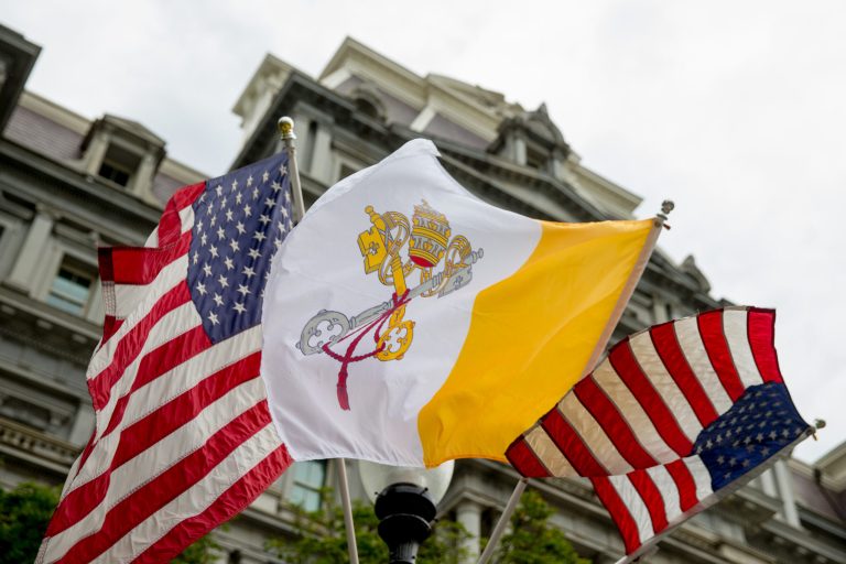 The Flag of Vatican City flies next to American flags along West Executive Avenue near the White House in Washington, Monday, Sept. 21, 2015, the day before Pope Francis arrives. (AP Photo/Andrew Harnik)