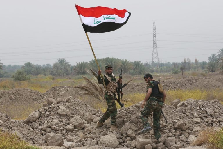 Iraq Shiite fighters make their way to the front line to fight militants from the extremist Islamic State group in Jurf al-Sakhar, 43 miles (70 kilometers) south of Baghdad, Iraq, Monday, Aug 18, 2014. Fighters of the voluntary armed group formed after the radical Shiite cleric Muqtatda al-Sadr called to protect holy shrines against possible attacks by Sunni militants. (AP Photo/ Hadi MIzban)