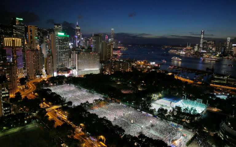 Tens of thousands of people attend a candlelight vigil at Victoria Park in Hong Kong Wednesday June 4, 2014, to mark the 25th anniversary of the June 4th Chinese military crackdown on the pro-democracy movement in Beijing. (AP Photo/Vincent Yu)