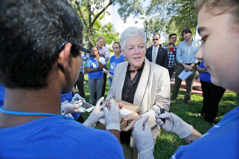EPA Administrator Gina McCarthy, center, listens as public magnet school students from MAST @ FIU Biscanye Bay Campus, Saad Masud, left, and Deanna Baumann explain how they are checking the salinity levels in water samples, Thursday, Oct. 9, 2014 in Miami Beach, Fla. McCarthy joined Democratic U.S. Sens. Bill Nelson and Sheldon Whitehouse on Thursday in a South Beach neighborhood that in recent years frequently was flooded by seasonal high tides. The city expects to spend up to $400 million over five years to add about 60 new storm water pumps to improve drainage and reduce flooding. (AP Photo/Wilfredo Lee)