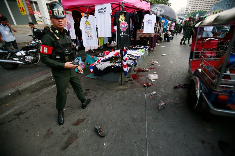 A military police officer stands at the scene of an explosion at a main protest site in Bangkok, Thailand, Sunday, Feb. 23, 2014. More than a dozen people were hurt Sunday by a small explosion at an anti-government protest in Bangkok, less than a day after a bloodier attack in an eastern province killed one child and left about three dozen people wounded. (AP Photo/Wally Santana)