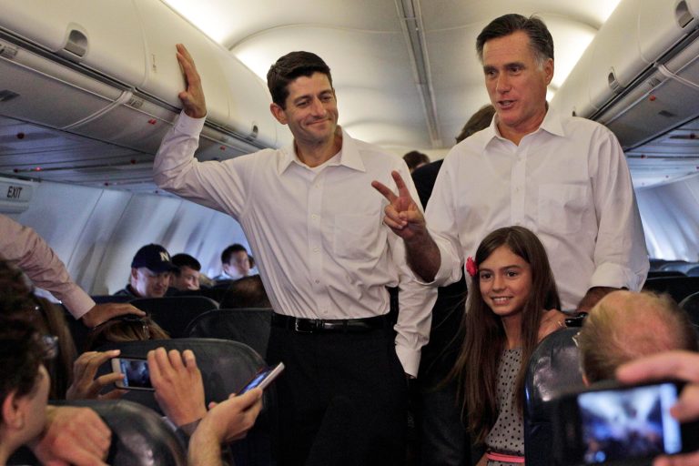 Republican presidential candidate, former Massachusetts Gov. Mitt Romney, right, and vice presidential running mate Rep. Paul Ryan R-Wis. are joined by Ronmey's granddaughter Chloe while talking to reporters on the charter flight between Virginia and North Carolina,  Saturday, Aug. 11, 2012.  (AP Photo/Mary Altaffer)