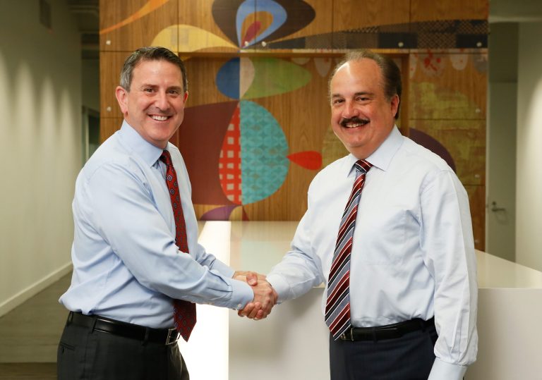 Target Chairman and CEO Brian Cornell, left, and CVS Health President and CEO Larry Merlo, right, meet up in New York, Monday, June 15, 2015, to announce a strategic agreement. Under the agreement, CVS Health will acquire, rebrand and operate Target's pharmacies and clinics. (Stuart Ramson/AP Images for Target and CVS Health)