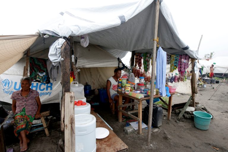 In this February 13, 2014 photo, typhoon survivors man their store at a tent city in Tacloban city, Leyte province in central Philippines. There are signs of progress since the monster storm slammed into the Philippines on Nov. 8, leaving more than 7,300 dead or missing and flattening hundreds of thousands of homes and other buildings. Many survivors have started rebuilding and debris is being slowly cleaned up and carted away. (AP Photo/Bullit Marquez, File)