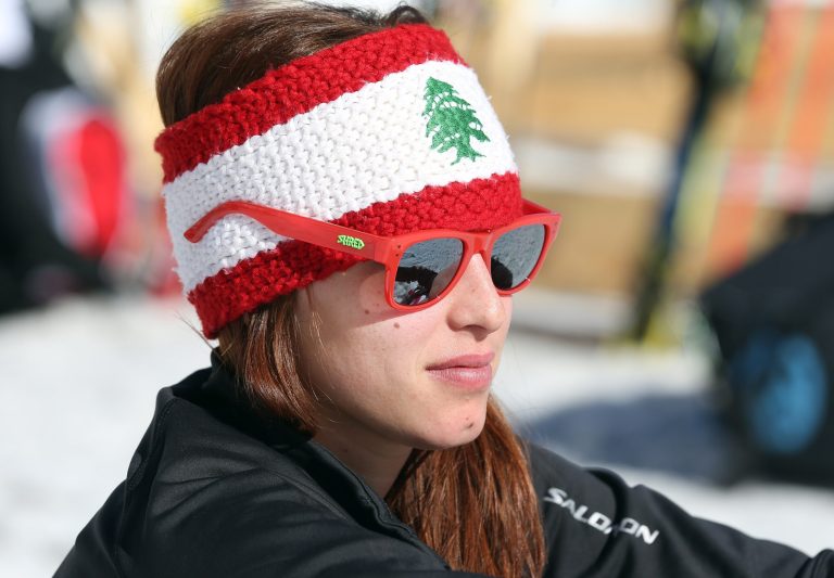 FILE- In this Thursday, Feb. 13, 2014 file photo, Lebanon's Jacky Chamoun sits near the alpine ski course finish area at the Sochi 2014 Winter Olympics, in Krasnaya Polyana, Russia. An old video of Jacky Chamoun posing for a snow calendar photo shoot that recently surfaced on the Internet, as she prepared for Alpine skiing at the Sochi Olympics, has prompted a Lebanese government official to order an investigation, while many thousands of supporters have jumped to her defense. (AP Photo/Luca Bruno, FILE)