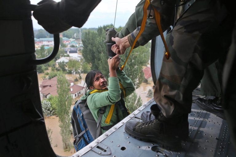 An Indian tourist cries as she is airlifted into a chopper in Srinagar, India, Tuesday, Sept. 9, 2014. The death toll from floods in Pakistan and India reached 400 on Tuesday and have put more than half a million people in peril and rendered thousands homeless in the two neighboring states. The tourist was stranded on the terrace of a five-storey hotel in central Srinagar. (AP Photo/Dar Yasin)