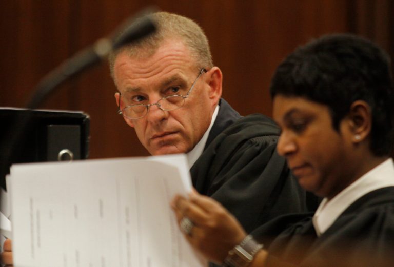 State prosecutor Gerrie Nel, prepares for a hearing in the Pretoria, South Africa high court, Thursday, March 28, 2013. The state is opposing the relaxation of bail conditions in the charges against athlete Pistorius who is charged with the shooting death of his girlfriend Reeva Steenkamp last month. (AP Photo/Denis Farrell)