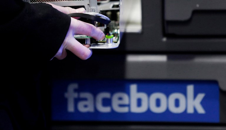 An employee fixes part of a web server inside the Facebook Inc. Prineville Data Center in Prineville, Oregon, U.S.