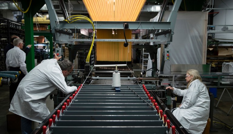 FILE - In this Thursday, March 23, 2017, file photo, workers manufacture thermal protection systems for NASA at Bally Ribbon Mills in Bally, Pa.