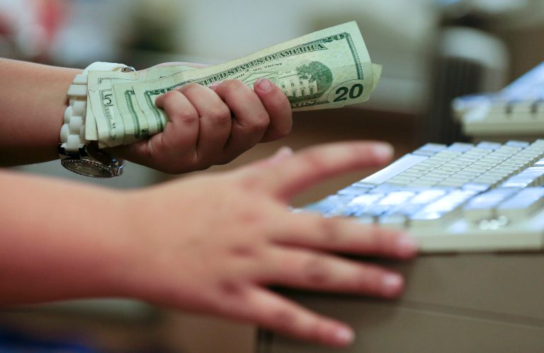 FILE - In this Friday, Nov. 23, 2012 file photo, a cashier rings up a cash sale at a Sears store, in Las Vegas. The Commerce Department reports how much consumers spent and earned in April, and The University of Michigan issues its index of consumer sentiment for May, on Friday, May 30, 2014. (AP Photo/Julie Jacobson, File)