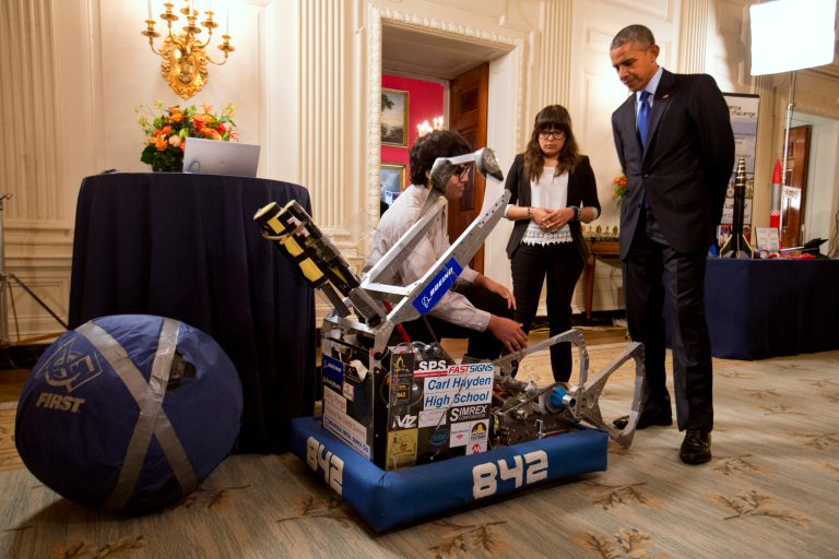 Sergio Corral, 17, left, and Isela Martinez, 17, of Phoenix, Ariz., show President Barack Obama their robot during his tour of the White House Science Fair in the White House, Monday, March 23, 2015 in Washington. (AP Photo/Jacquelyn Martin)
