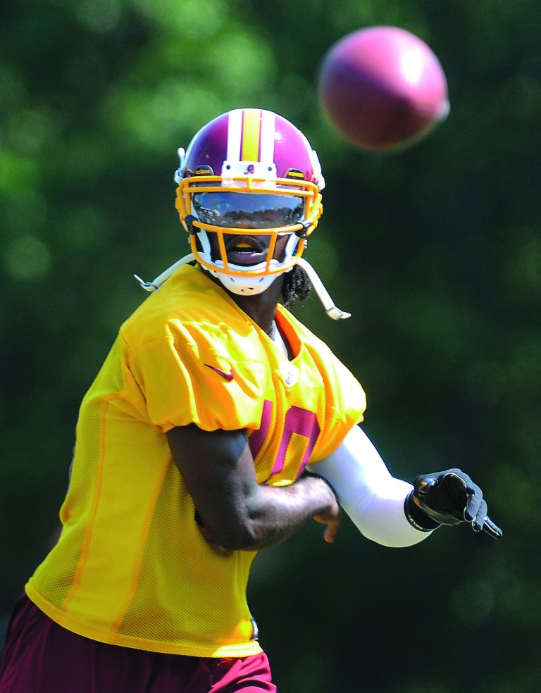 Richard Lipski/AP
Quarterback Robert Griffin III and the Redskins will face the Bears on Saturday.